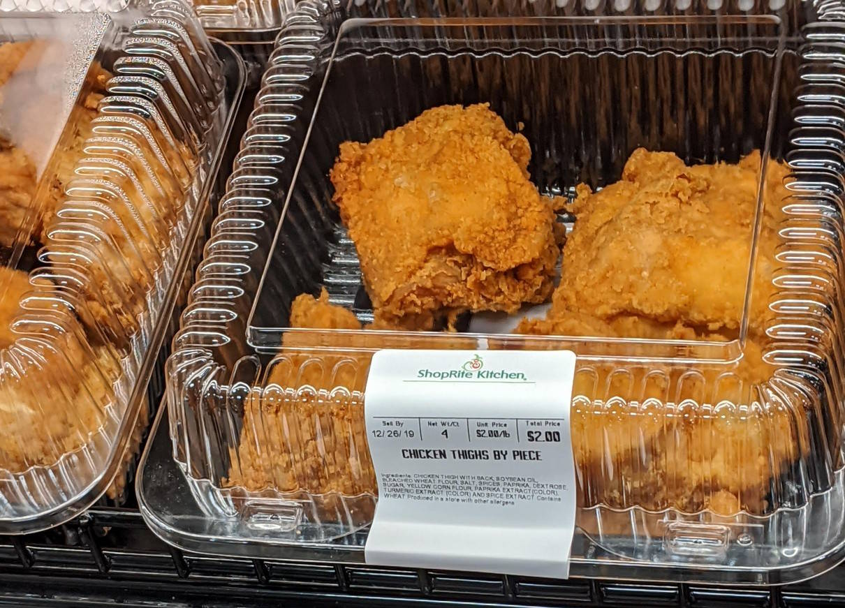 Close-up of a fried chicken box with a sell-by in December 2019, $2 for 4 pieces.
