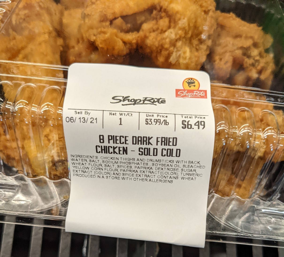Close-up of a fried chicken box with a sell-by in June 2021, $6.49 for 8 pieces.