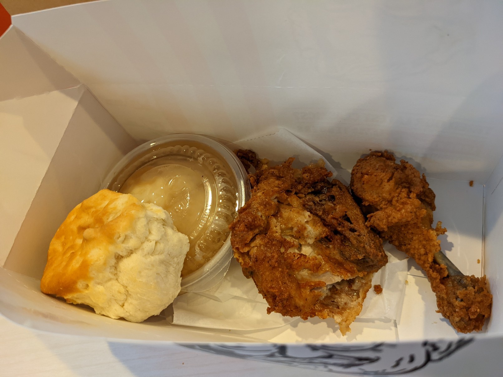 The KFC two piece dark meat meal, with a thigh, drumstick, biscuit, and mashed potatoes.