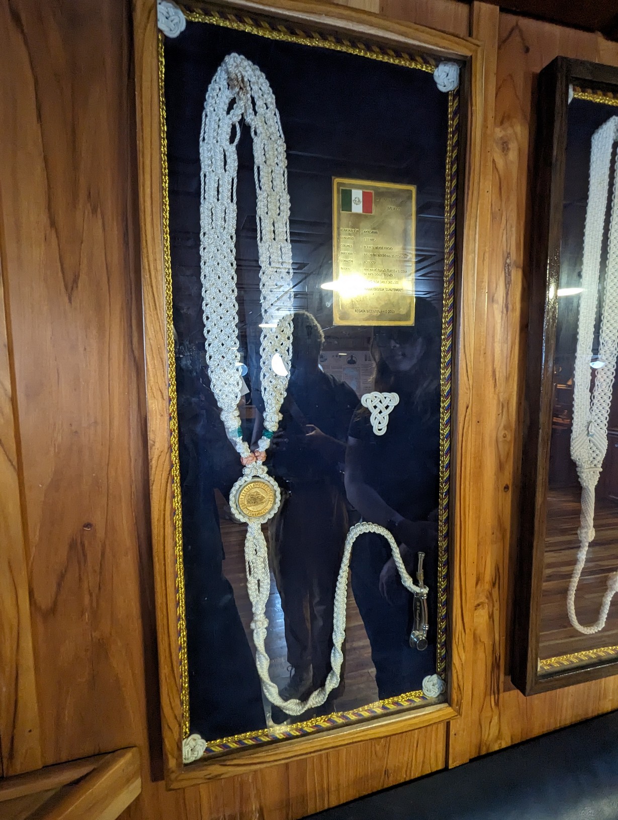 A boatswain's whistle on an elaborately braided rope lanyard.