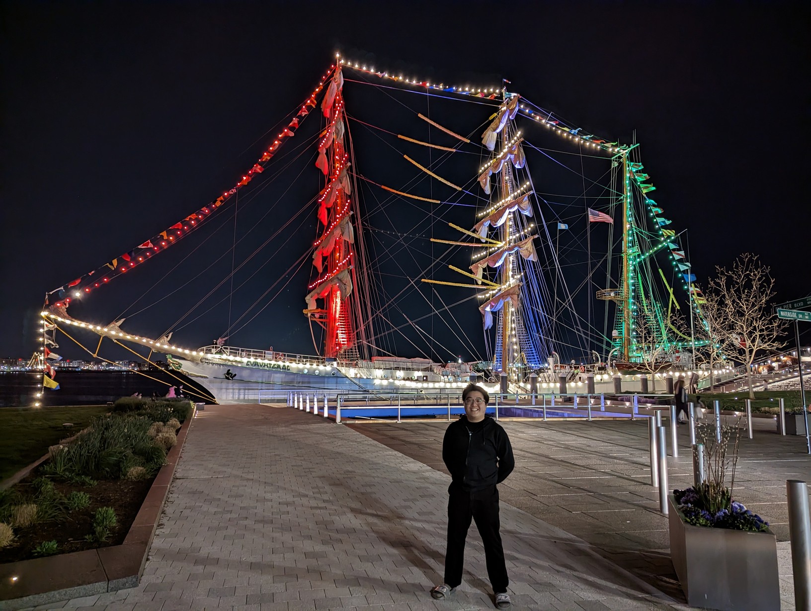 Me standing in front of the Cuauhtémoc. The masts lit up and in the color of the Mexican flag.